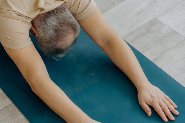 Person performing a calm, focused yoga stretch.